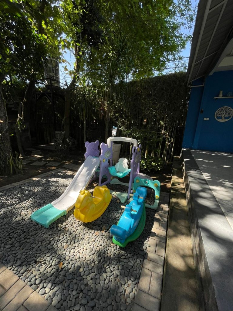 Area bermain anak-anak dengan mainan dan properti ayunan kecil